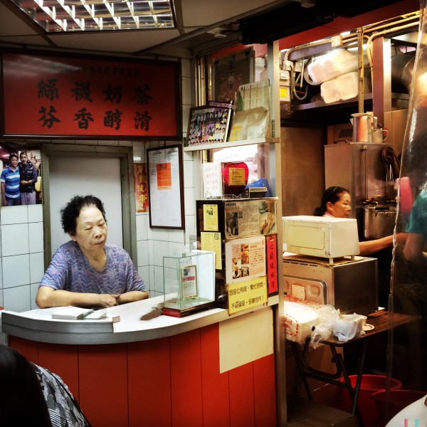 Lady at the cash register, Hong Kong, by Charlie Grosso